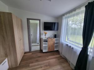 a living room with a television and a window at Karlskovhuset in Give