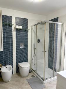 a bathroom with a shower and a toilet and a sink at B&B Mamie in Bellizzi