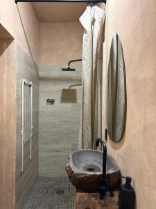 a bathroom with a stone sink and a mirror at Ánimo Perro in Sayulita +29 photos