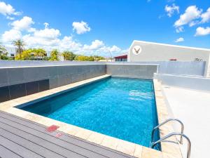 a swimming pool on the roof of a house at Movic's Modern Airbnb in Windhoek