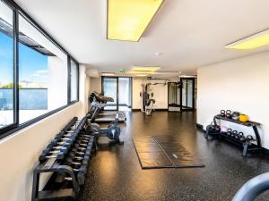 a gym with treadmills and machines in a room at Movic's Modern Airbnb in Windhoek
