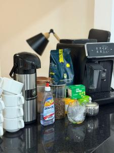 a counter top with a coffee maker and some food at Hotel Santorine Plaza - Itabira - Próximo a Fundação Cultural Carlos Drummond Andrade in Itabira