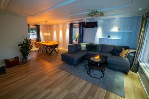 a living room with a couch and a table at Cosy house in Ringebu kommune in Ringebu