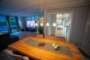 a living room with a wooden table and a kitchen at Cosy house in Ringebu kommune in Ringebu