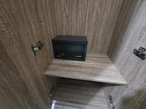 a television sitting on a shelf in a room at A Casa di Nonna in Riposto