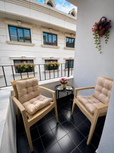 two chairs and a table on a balcony at Huzur Apart Hotel in Istanbul +65 photos