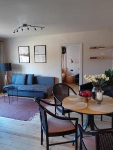 a living room with a couch and a table at BOHO Ogre in Ogre +21 photos