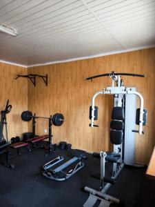 a gym with several tread machines in a room at Agroturystyka Kuźnia in Neple