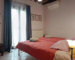 a bedroom with two beds and a window at Villa Rahes Kofini in Mykonos