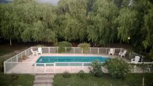 a swimming pool with two chairs at Residencial Castelar in Merlo +4 photos