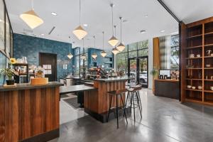 a restaurant with a bar with stools at Sentral West Midtown at Star Metals in Atlanta