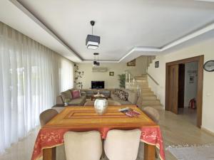 a living room with a table and a couch at Paradise Town Villa Marina in Belek