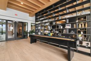 a pool table in a room with a wall of shelves at Sentral West Midtown at Star Metals in Atlanta