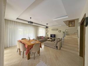 a living room with a table and a couch at Paradise Town Villa Marina in Belek
