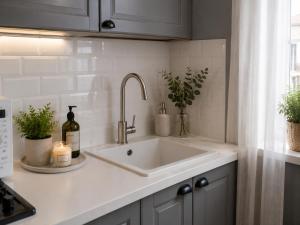 a kitchen counter with a white sink and a window at Beach apartment in the center in Sanremo +26 photos