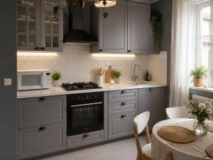 a kitchen with a stove and a microwave and a table at Beach apartment in the center in Sanremo