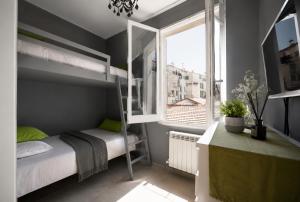 a bedroom with a bunk bed and a window at Beach apartment in the center in Sanremo