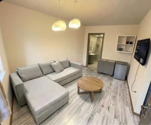 a living room with a couch and a table at Geamare Studios in Kálamos +2 photos