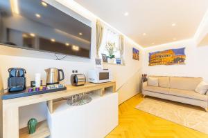 a living room with a couch and a tv at Charma Luxury Apartment - ROMA in Rome