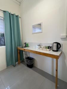 a bathroom with a wooden counter with a sink at Downtown Hostel Jamaica in Kingston