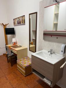 a bathroom with a sink and a desk at Alloggi Al Giardino & La Suite in Occhiobello +23 photos