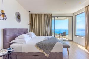 a bedroom with a large bed and a large window at Villa Bellevue Bast in Baška Voda +75 photos