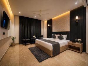 a hotel room with a bed and a desk and a desk at Hotel Sunshine in Surajpur Jikkla +50 photos