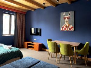 a room with a table and a deer wearing sunglasses at New Gudauri Studio N207 in Suites! in Gudauri