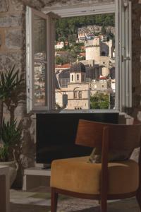 a room with a window with a view of a city at Dominus Little Palace in Dubrovnik