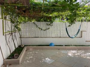 a patio with a blue ball and a fence at באר מרים in Ashkelon