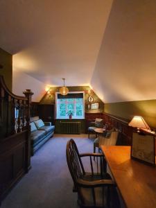 a living room with a couch and a table at Bel And The Dragon-Churt in Farnham