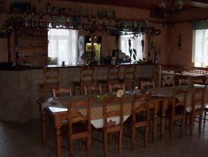 a dining room filled with tables and chairs at Penzion U červených vrat in Chudolazy