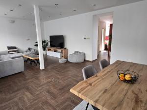 a living room with a wooden table and a couch at Post 25 in Slezská Ostrava