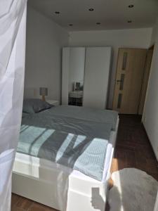 a bedroom with a bed with a blue blanket at Post 25 in Slezská Ostrava