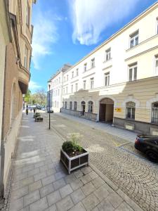 an empty street with a building and a car at Post 25 in Slezská Ostrava