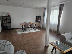 a living room with a table and chairs and a couch at Post 25 in Slezská Ostrava