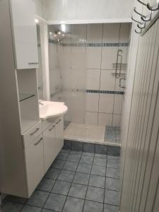 a white bathroom with a shower and a sink at La maison du petit peintre in Villaines-sous-Lucé +31 photos