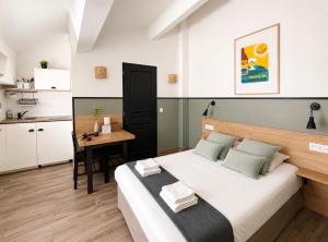 a bedroom with a large bed and a small table at Casa Stay in Aix-en-Provence