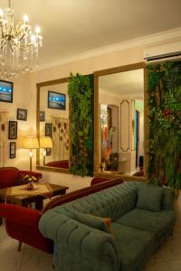 a living room with a green couch and a mirror at Hotel and Restaurant "VILLA GIVISI" in Lagodekhi
