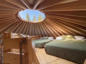 a bedroom with two beds in a yurt at Exode en Nature in Sainte-Rose-du-Nord
