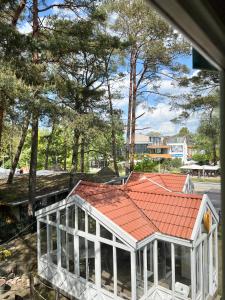 a house with a red roof at ThaiThanee COZY HOUSE in Palanga