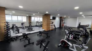a gym with several treadmills and machines in it at Aeroporto Gru, Ar Condicionado, Piscina+Academia 7 in Guarulhos