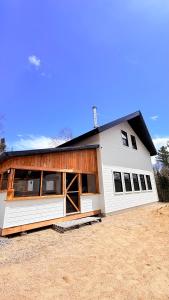 a white house with a black roof at Le Shack du Nord in Mont-Laurier
