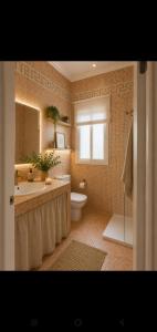 a bathroom with a tub and a sink and a toilet at Hogar Leticia in Seville