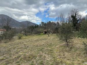 a field with trees and a house in the distance at Chambre à louer dans villa ou Location maison entière in Montjoux +4 photos