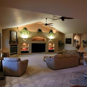 a living room with two couches and a flat screen tv at Monument Resort in Grand Junction