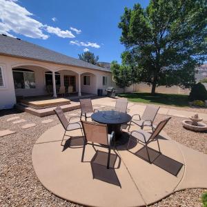 a patio with a table and chairs in front of a house at Monument Resort in Grand Junction