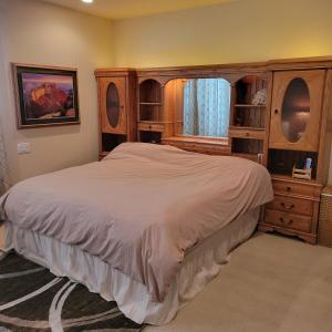 a bedroom with a large bed and wooden cabinets at Monument Resort in Grand Junction +47 photos