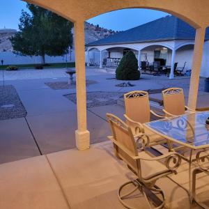 a patio with chairs and a table and a house at Monument Resort in Grand Junction