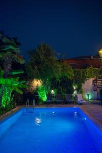 a large swimming pool at night with at Hotel and Restaurant "VILLA GIVISI" in Lagodekhi